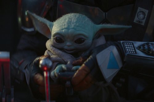 baby yoda in mando’s lap